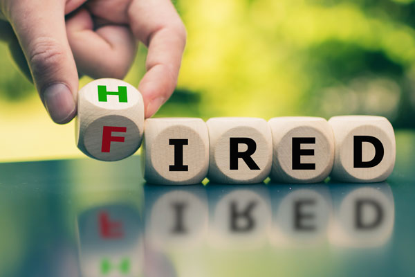 Picture of letter cubes spelling hired and fired.